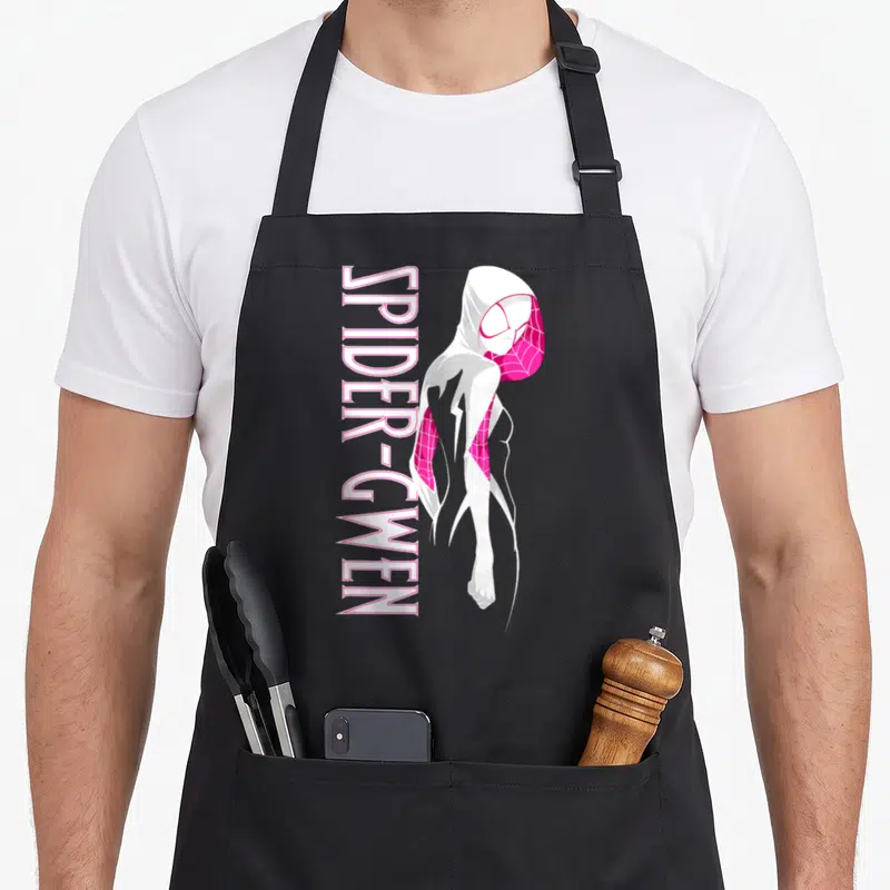 Portrait spider apron - Vertical SPIDER-GWEN text next to white and pink hooded character — shown on a black cotton canvas apron against a white background