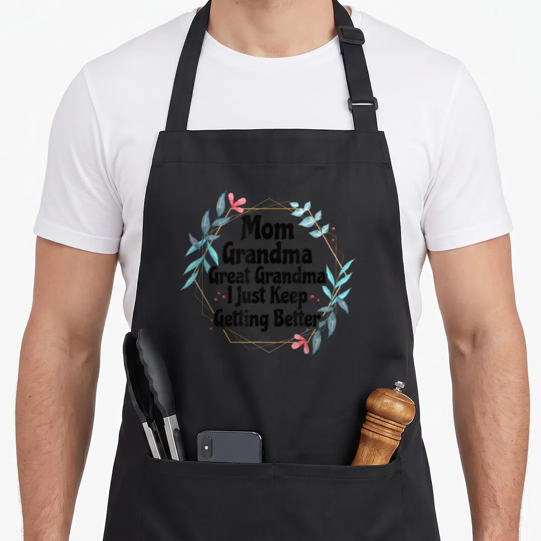 Getting great grandma apron - Mom Grandma Great Grandma I Just Keep Getting Better text with blue watercolor leaves — shown on a black cotton canvas apron against a white background