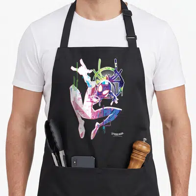 Spiderverse watercolors apron - Retro Spider-Man graphic in white pink blue purple with web pattern and logo text — shown on a black cotton canvas apron against a white background