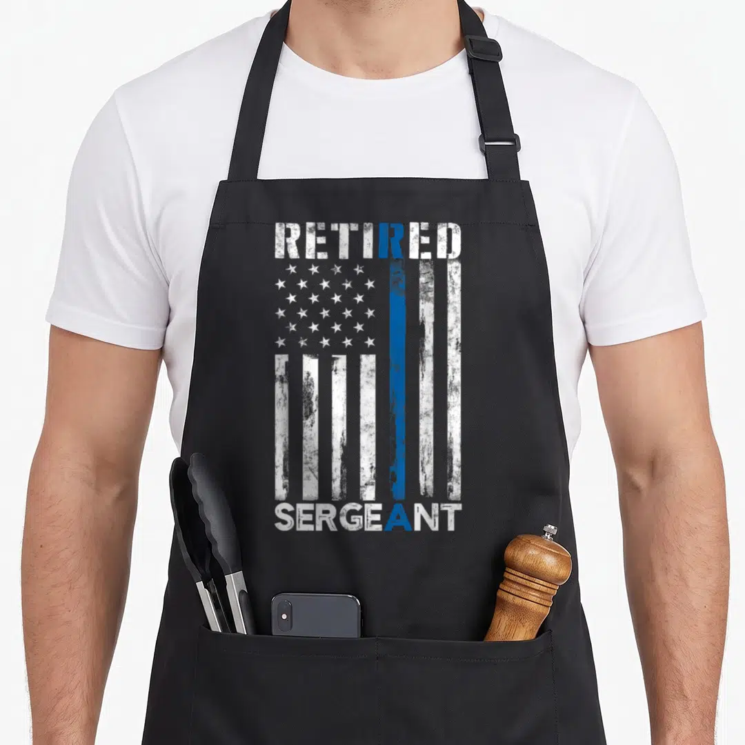 Retired sergeant american flag apron - Distressed American flag with thin blue line and text Retired Sergeant — shown on a black cotton canvas apron against a white background