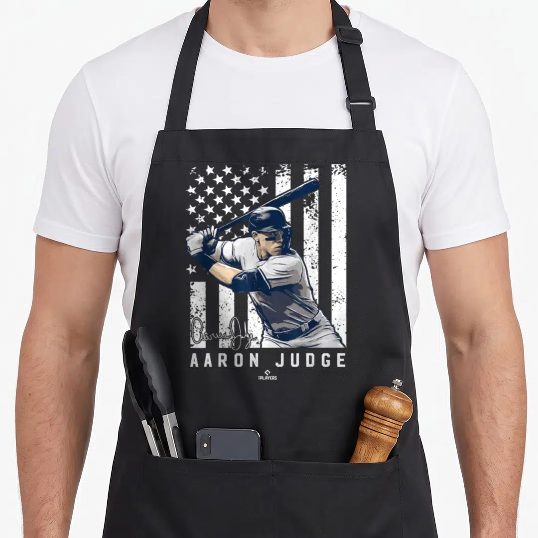 Mlbpa new york apron - Aaron Judge batting graphic over distressed flag with signature and name text — shown on a black cotton canvas apron against a white background