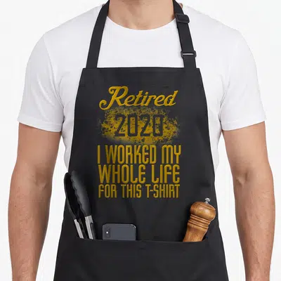 Retired worked whole retirement apron - Gold stacked typography reading Retired 2020 I worked my whole life for this — shown on a black cotton canvas apron against a white background