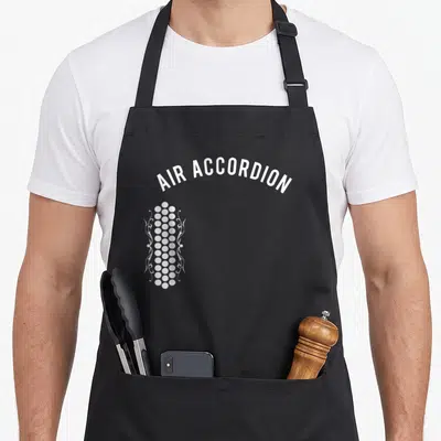 Original accordion apron - White arched text AIR ACCORDION above vertical column of dots and swirls — shown on a black cotton canvas apron against a white background