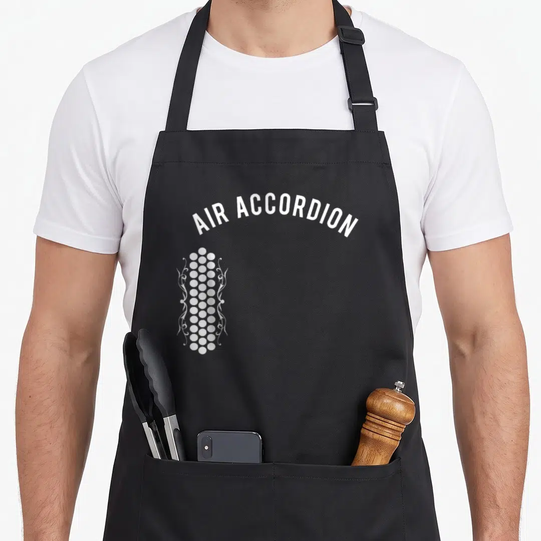 Original accordion apron - White arched text AIR ACCORDION above vertical column of dots and swirls — shown on a black cotton canvas apron against a white background