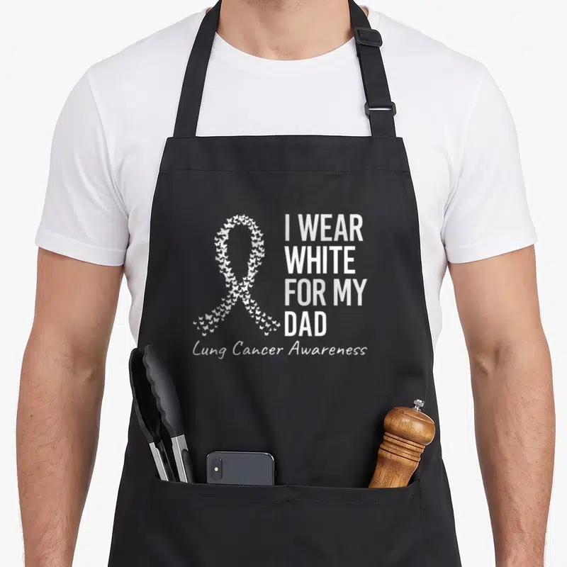 Lung cancer ribbon apron - White awareness ribbon made of small butterflies with stacked text I Wear White For My Dad — shown on a black cotton canvas apron against a white background