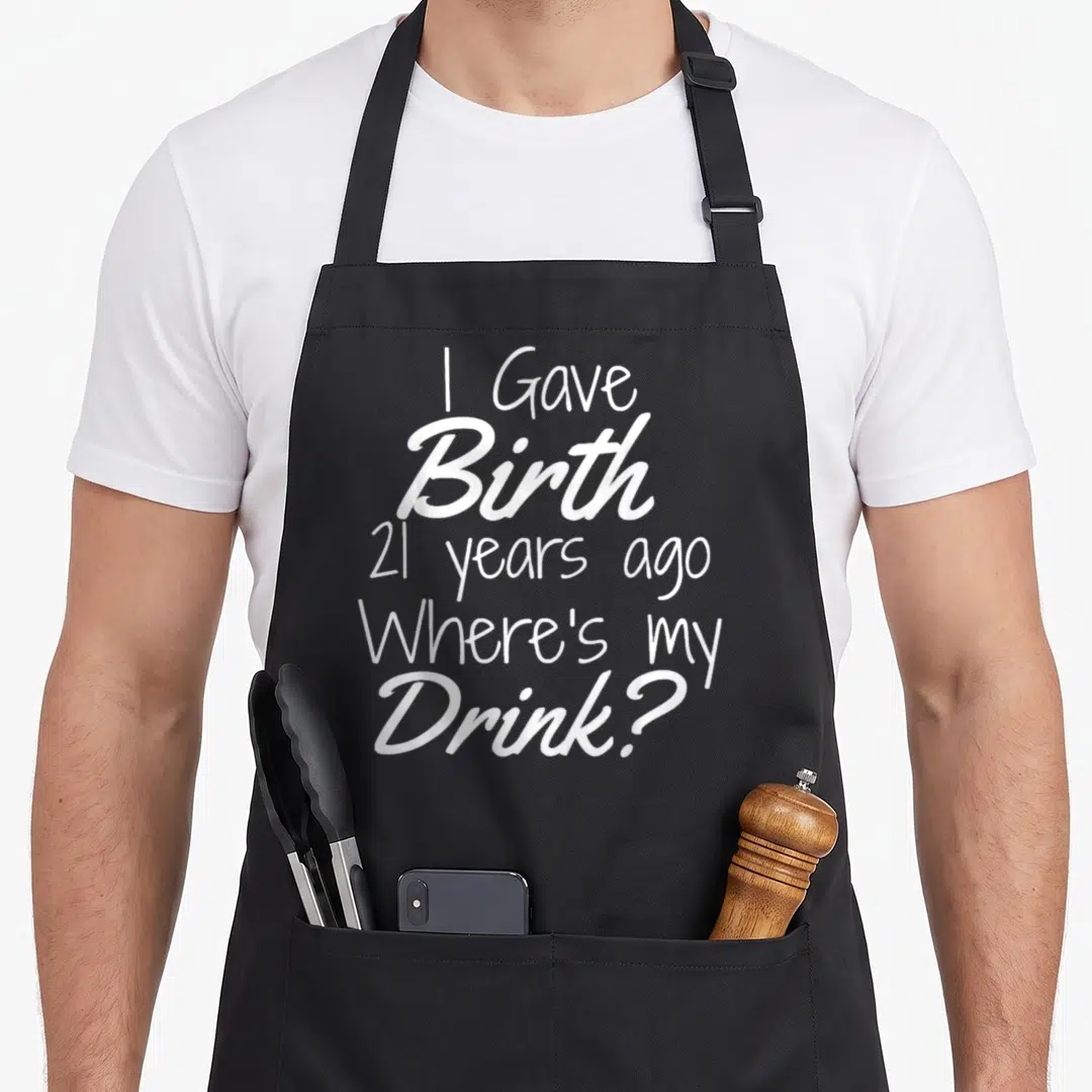 21st dad and son aprons - White stacked text reading I Gave Birth 21 years ago Where's my Drink — shown on a black cotton canvas apron against a white background