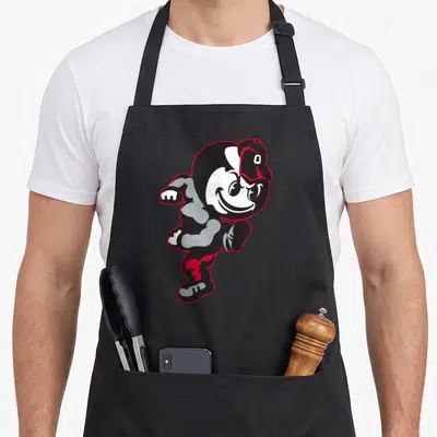 Brutus ohio girl apron - Cartoon mascot running in black white red and grey — shown on a black cotton canvas apron against a white background