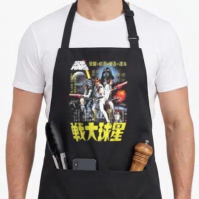 Chinese movie poster apron - Retro Star Wars poster print with Luke Skywalker, yellow Chinese text, and droids C-3PO — shown on a black cotton canvas apron against a white background