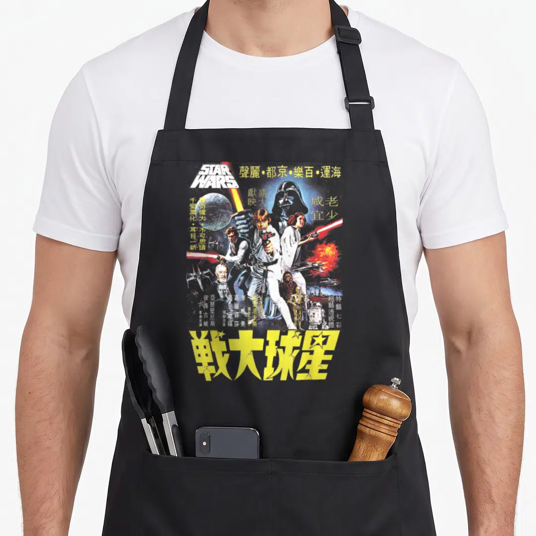 Chinese movie poster apron - Retro Star Wars poster print with Luke Skywalker, yellow Chinese text, and droids C-3PO — shown on a black cotton canvas apron against a white background