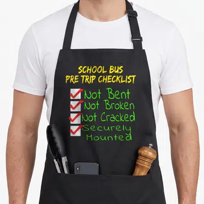 Cdl bus driver apron - Yellow SCHOOL BUS PRE TRIP CHECKLIST text with four white boxes, red ticks, and green status text — shown on a black cotton canvas apron against a white background