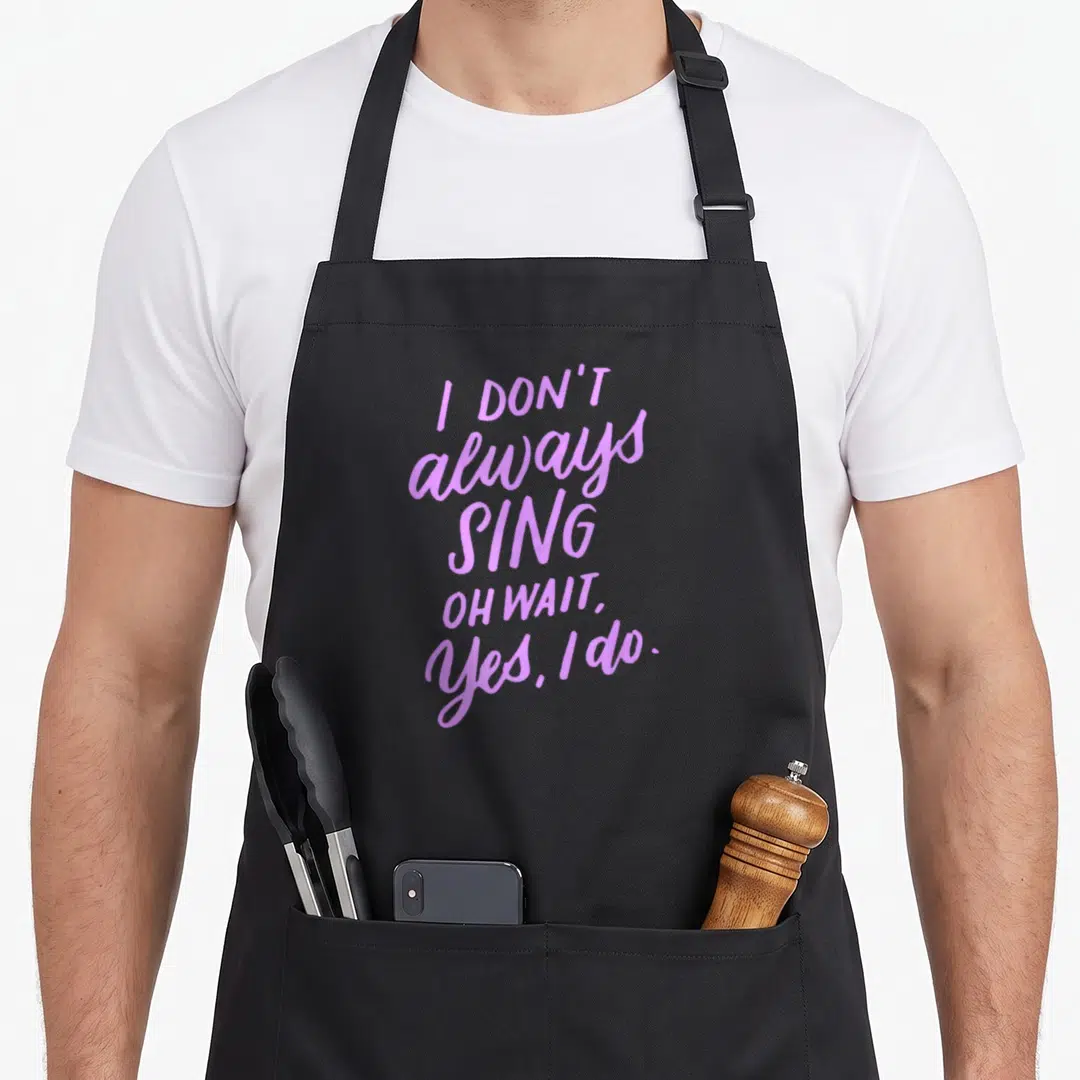 Alway theater apron - Purple stacked text reading I Don't Always Sing Oh Wait Yes I Do — shown on a black cotton canvas apron against a white background