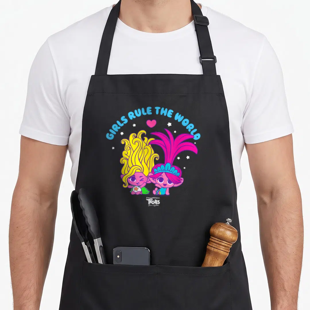 Together troll apron - GIRLS RULE THE WORLD text over two cartoon trolls with heart and stars — shown on a black cotton canvas apron against a white background