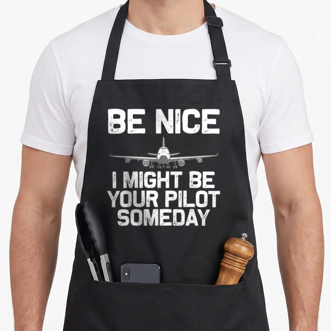 Pilot aviation airplane apron - White distressed airplane centered between BE NICE and pilot text on black apron — shown on a black cotton canvas apron against a white background