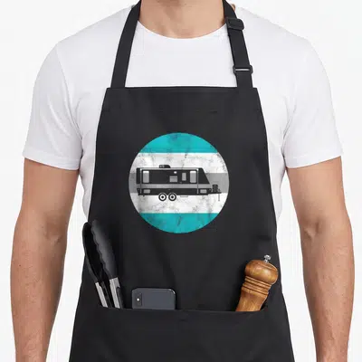 Funny camper trailer apron - Grey camper trailer silhouette inside a circle of horizontal turquoise, white, and grey — shown on a black cotton canvas apron against a white background