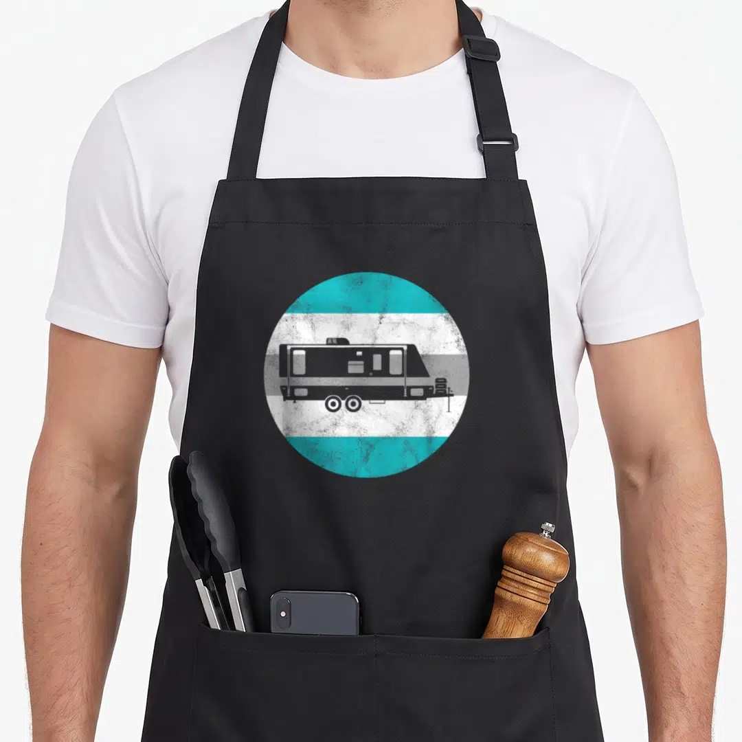 Funny camper trailer apron - Grey camper trailer silhouette inside a circle of horizontal turquoise, white, and grey — shown on a black cotton canvas apron against a white background