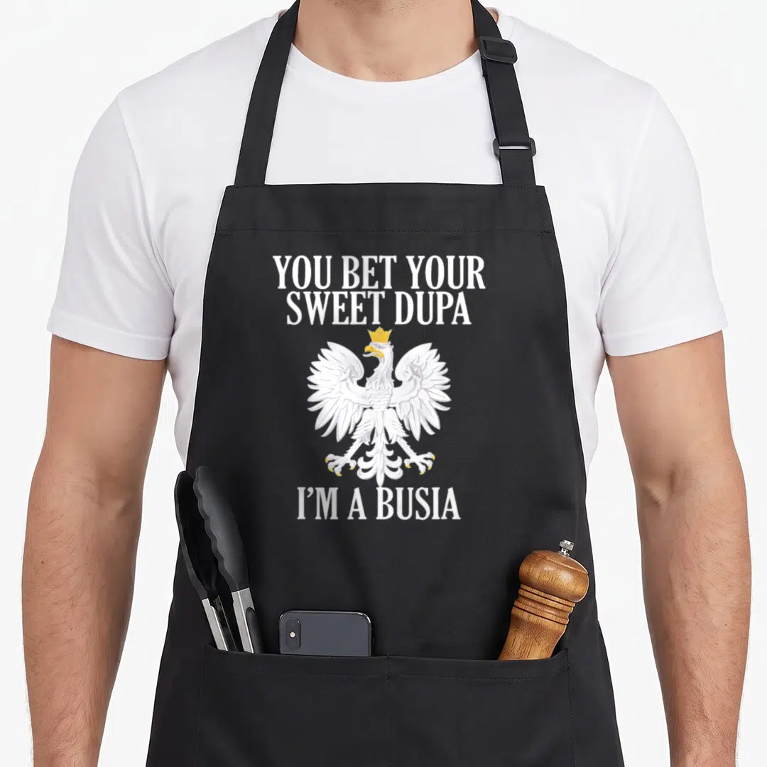 Bet day family apron - White eagle with gold crown and You Bet Your Sweet Dupa I'm a Busia text — shown on a black cotton canvas apron against a white background