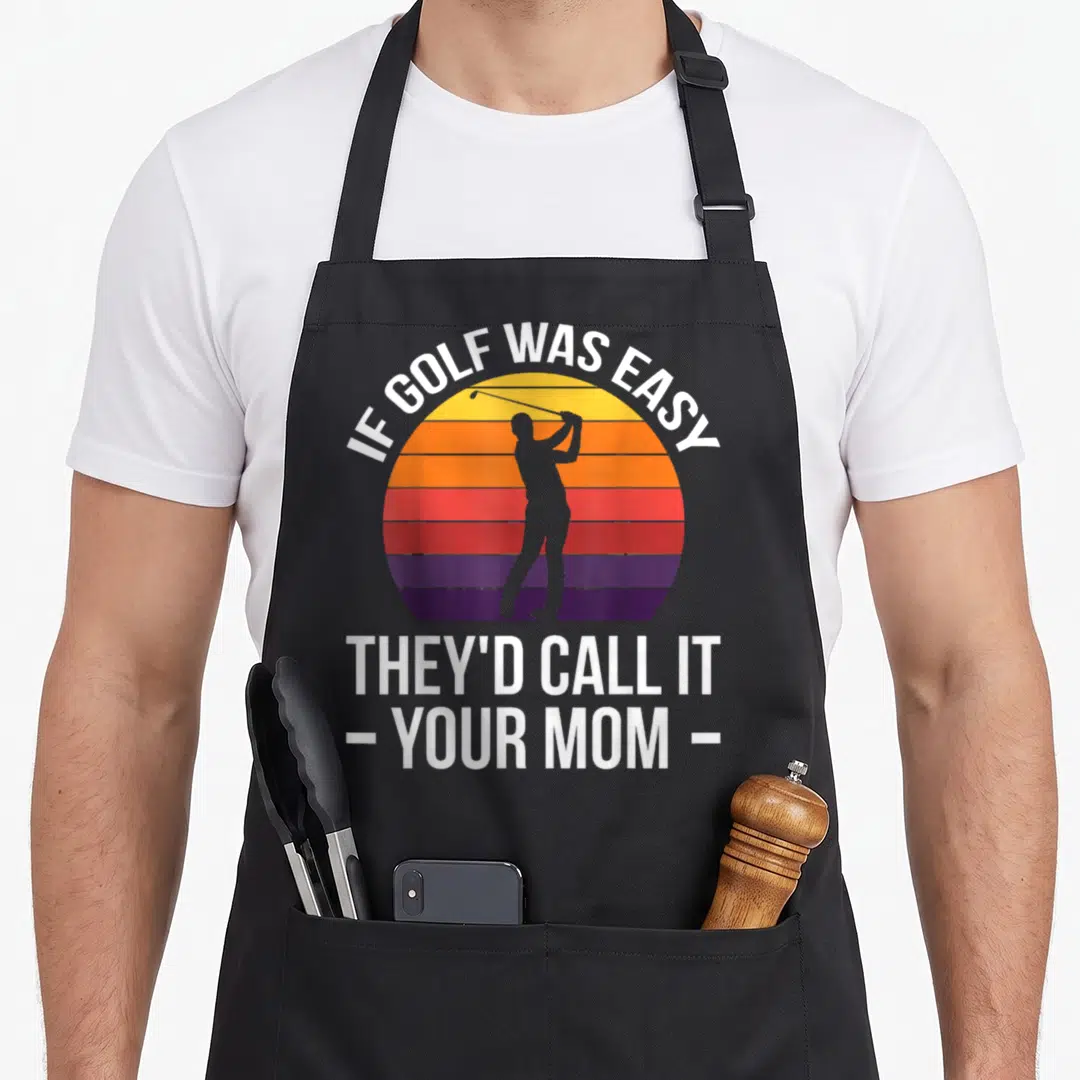 Easy theyd golf apron - Golfer silhouette in striped sun with white text IF GOLF WAS EASY THEY'D CALL IT YOUR MOM — shown on a black cotton canvas apron against a white background