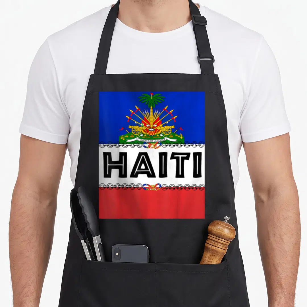 Ayiti pride apron - Haitian flag with large black HAITI text and coat of arms on blue red white background — shown on a black cotton canvas apron against a white background