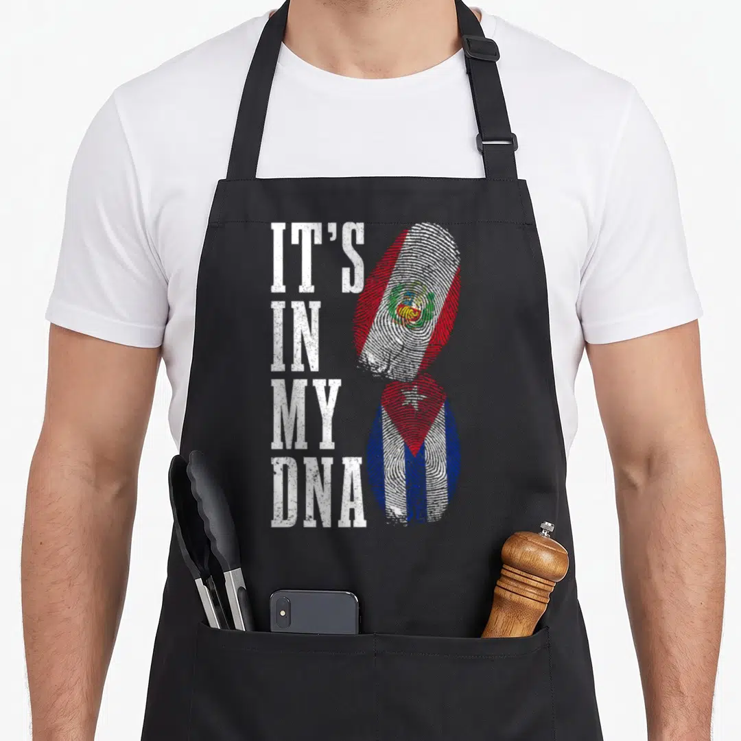 Cuba peru pride apron - IT'S IN MY DNA text next to stacked Peruvian and Cuban fingerprint flags in red white and blue — shown on a black cotton canvas apron against a white background
