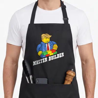 Youth grill master apron - Cartoon builder figure holding colorful bricks above curved white text — shown on a black cotton canvas apron against a white background