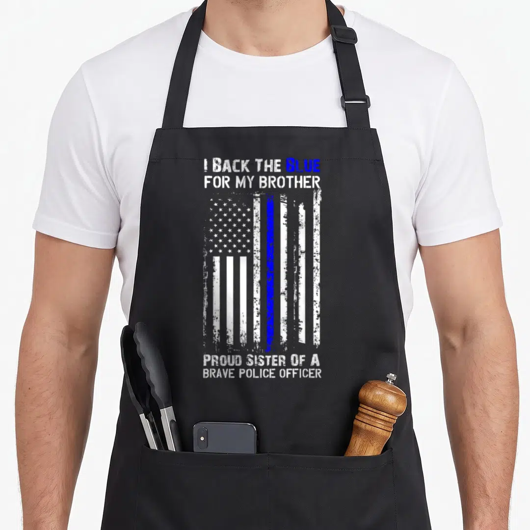 Flag police apron - Distressed white and blue flag with text I Back The Blue For My Brother Proud Sister Of A Brave — shown on a black cotton canvas apron against a white background