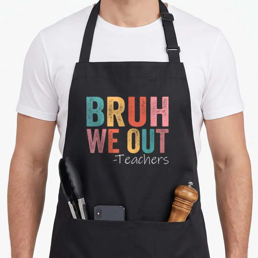 Bruh school teacher apron - Stacked colorful typography reading BRUH WE OUT -Teachers on black fabric — shown on a black cotton canvas apron against a white background