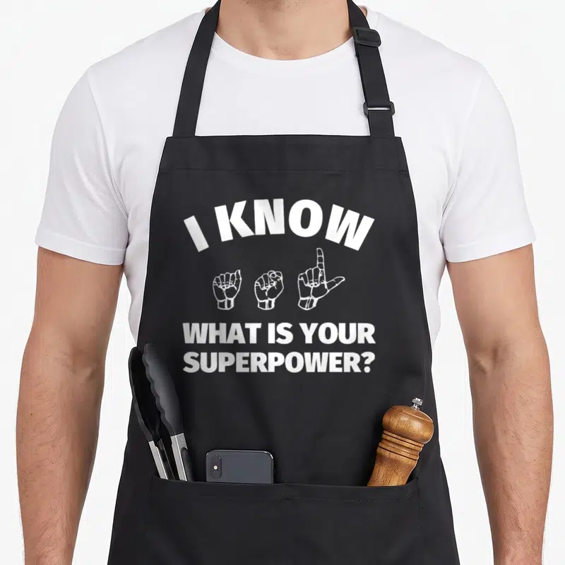 Signing asl sign for apron - White text I KNOW and three hand signs on black bib apron — shown on a black cotton canvas apron against a white background