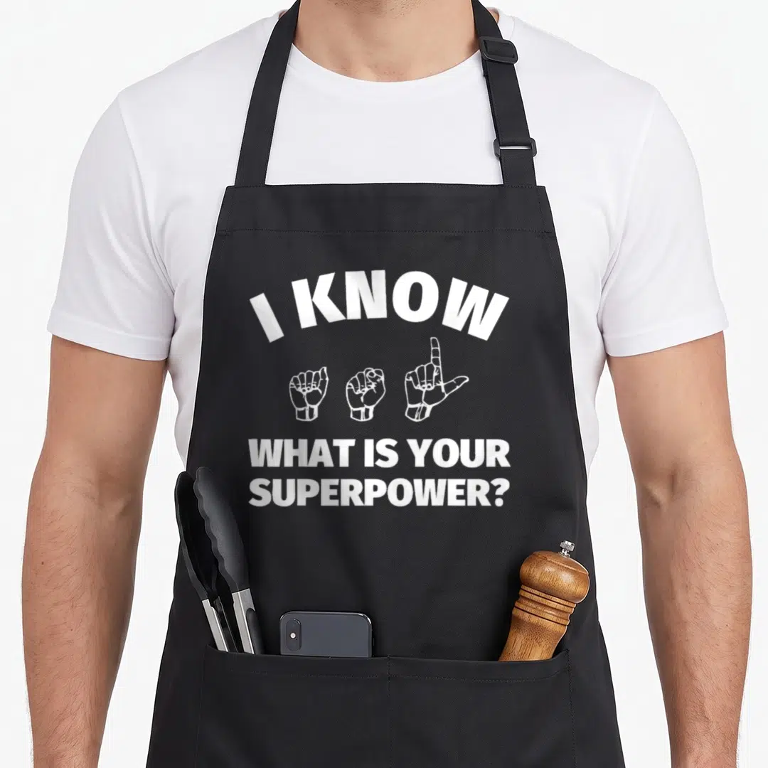 Signing asl sign for apron - White text I KNOW and three hand signs on black bib apron — shown on a black cotton canvas apron against a white background