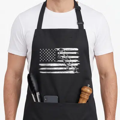 Archery 4th of july apron - White compound bow overlaid on a distressed American flag pattern — shown on a black cotton canvas apron against a white background