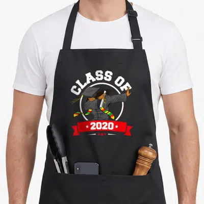 Dabbing funny graduation apron - Cartoon graduate dabbing holding diploma with Class of 2020 text and red ribbon — shown on a black cotton canvas apron against a white background