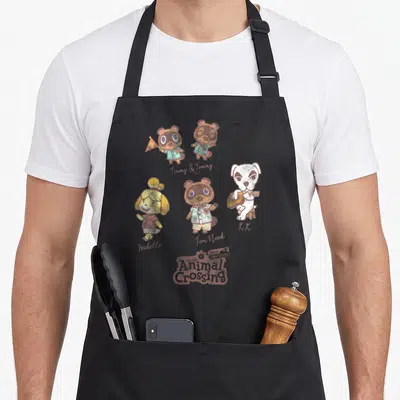 Horizon game aprons - Animal Crossing characters Timmy Tommy Isabelle Tom Nook K.K. with script names and logo — shown on a black cotton canvas apron against a white background