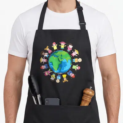 Around earth day apron - Cartoon globe with children holding hands in a circle wearing blue, green, yellow, pink — shown on a black cotton canvas apron against a white background