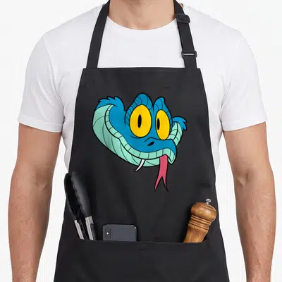 Gary halloween apron - Cartoon blue snake head with yellow eyes, pink tongue, and single tooth — shown on a black cotton canvas apron against a white background