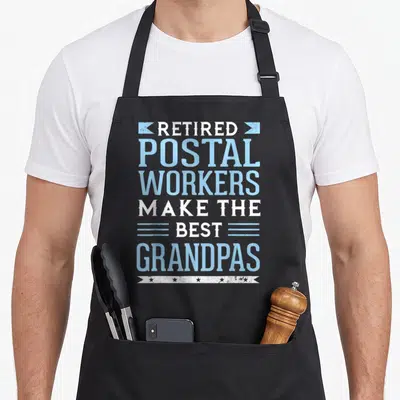 Funny retired postal aprons - Blue and white stacked text reading Retired Postal Workers Make The Best Grandpas — shown on a black cotton canvas apron against a white background
