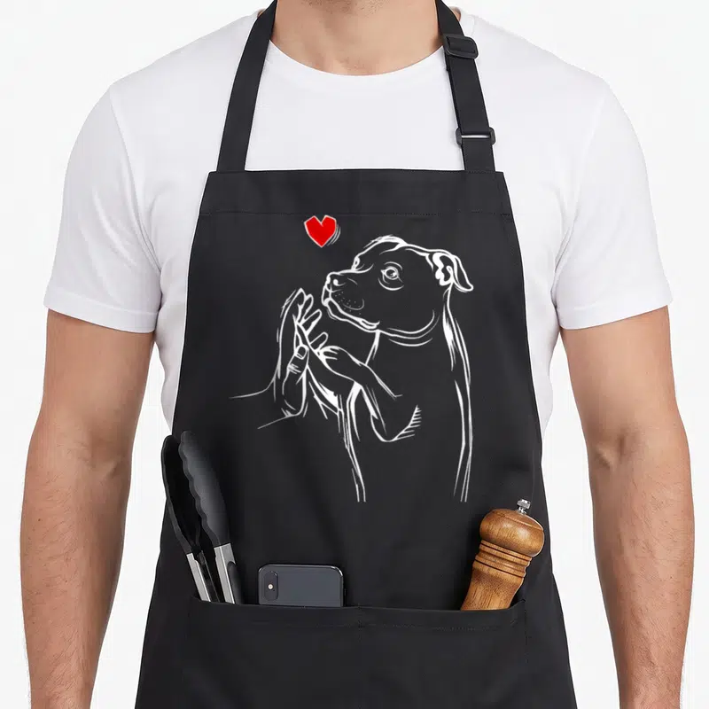 Bull personalized dog apron - White line art of dog head and hand touching chin with red heart above — shown on a black cotton canvas apron against a white background