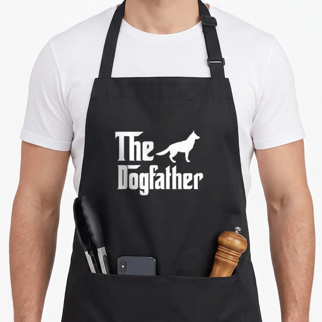 Dogfather german apron - White The Dogfather text and dog silhouette on black apron — shown on a black cotton canvas apron against a white background