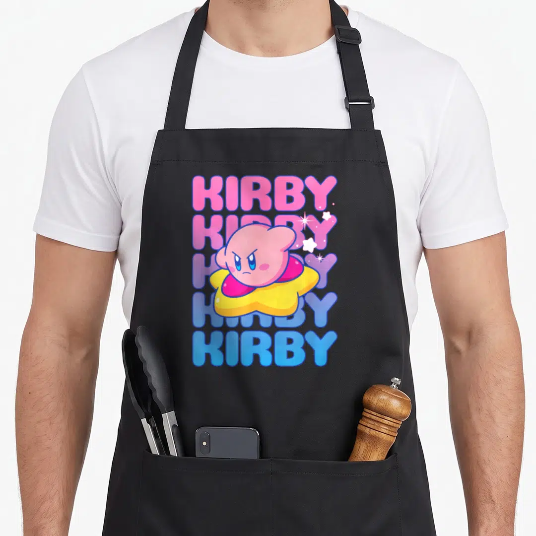 Stack bubble apron - Pink Kirby character on yellow star over five stacked KIRBY words in pink blue purple — shown on a black cotton canvas apron against a white background