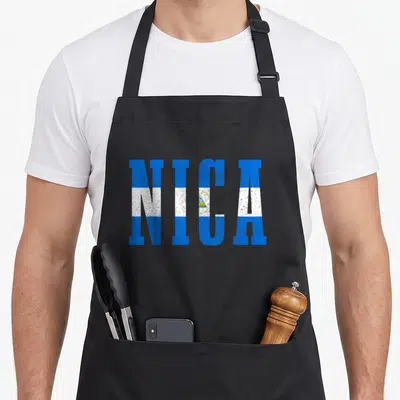 Souvenir nicaragua apron - NICA text in blue white and yellow flag colors — shown on a black cotton canvas apron against a white background