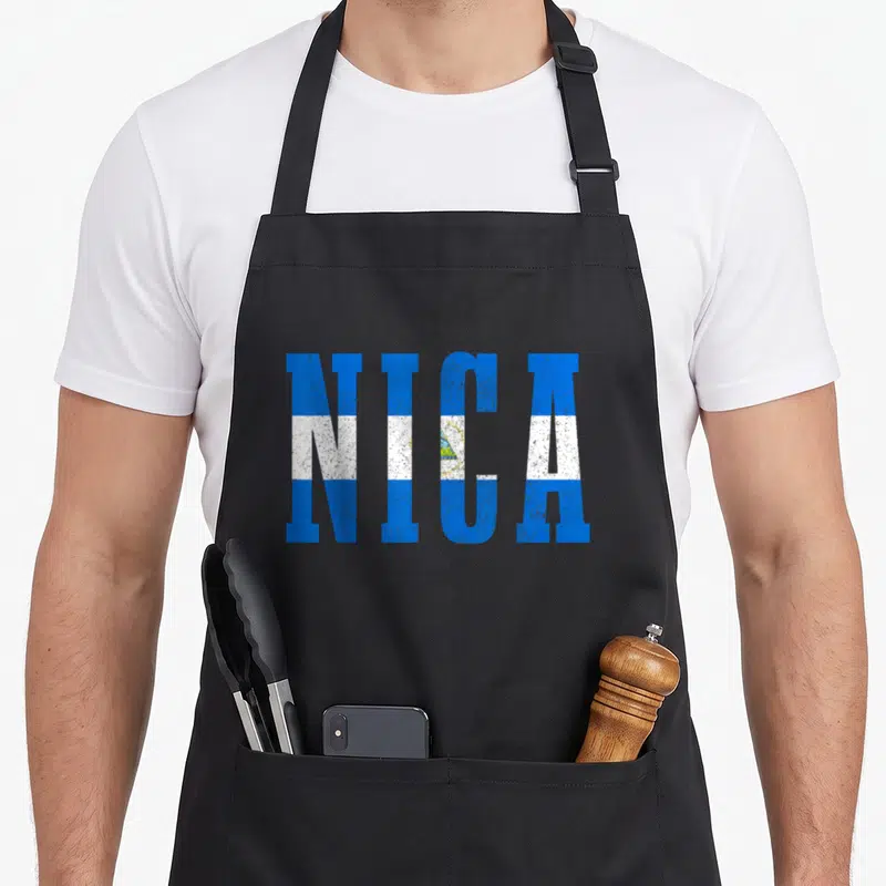 Souvenir nicaragua apron - NICA text in blue white and yellow flag colors — shown on a black cotton canvas apron against a white background