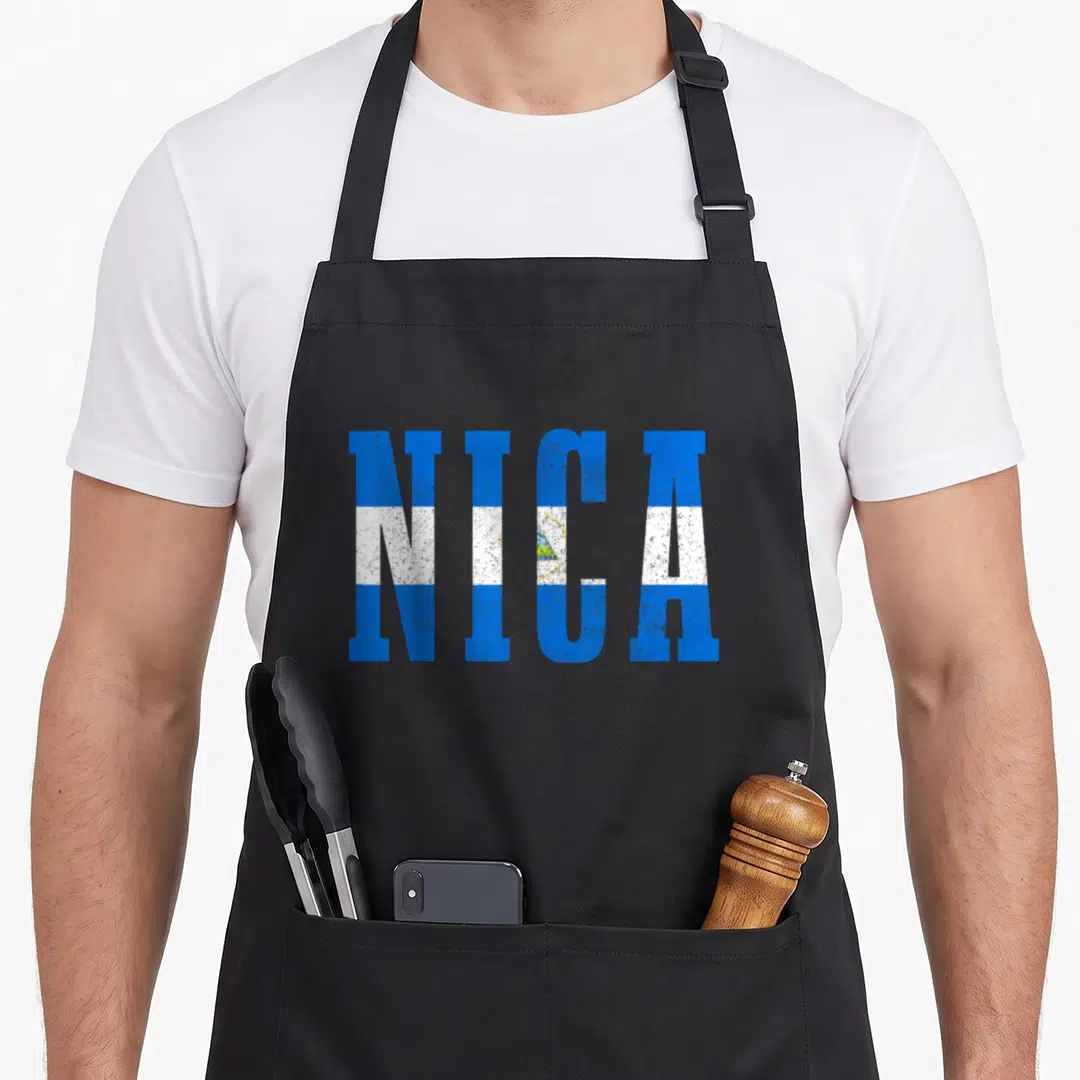 Souvenir nicaragua apron - NICA text in blue white and yellow flag colors — shown on a black cotton canvas apron against a white background