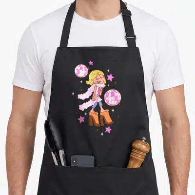 Mcguire iconic aprons - Cartoon woman in pink boa and orange heels with two disco balls and pink stars — shown on a black cotton canvas apron against a white background