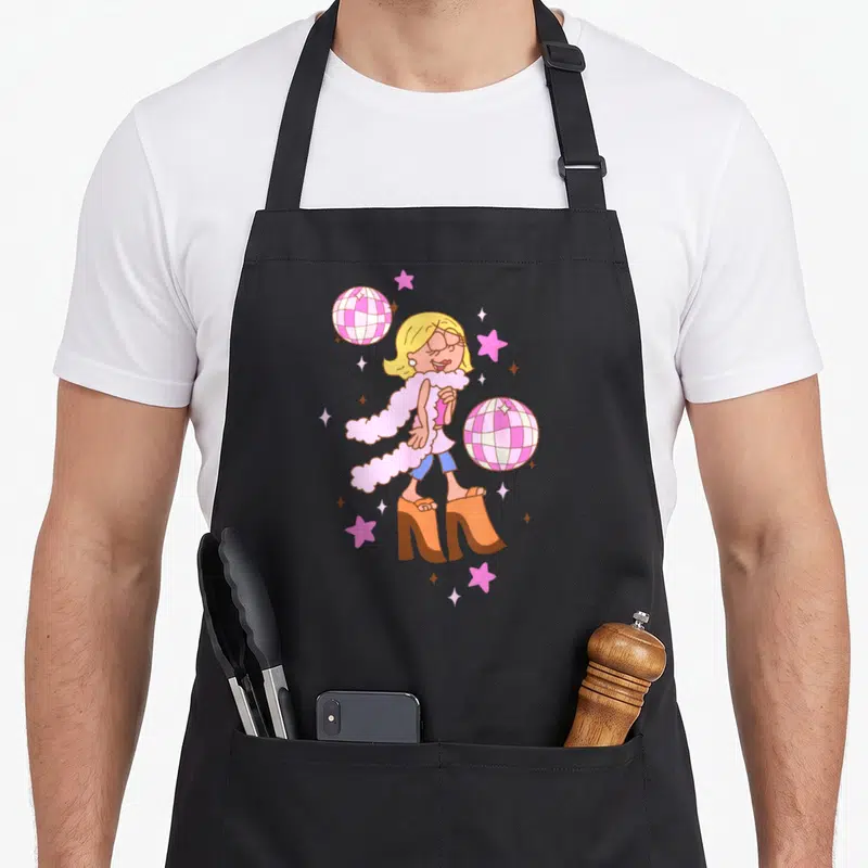 Mcguire iconic aprons - Cartoon woman in pink boa and orange heels with two disco balls and pink stars — shown on a black cotton canvas apron against a white background