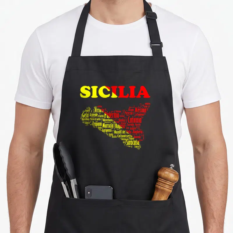 Souvenir map sicily apron - Sicily map graphic formed by yellow and red city names including Palermo, Messina — shown on a black cotton canvas apron against a white background