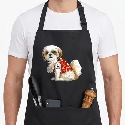 Shih tattoo aprons - Realistic Shih Tzu in red shirt with I Love Dad tattoo on leg — shown on a black cotton canvas apron against a white background