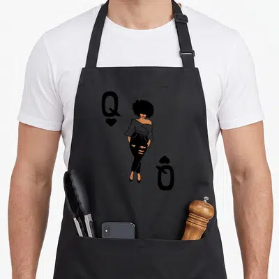Punky queen apron - Stylized woman with afro centered between Q and heart symbols in black and tan on grey — shown on a black cotton canvas apron against a white background