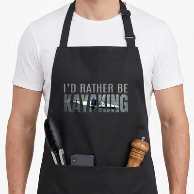 Accessory kayak girl apron - I'D Rather Be Kayaking text with kayaker photo inside letters on grey background — shown on a black cotton canvas apron against a white background
