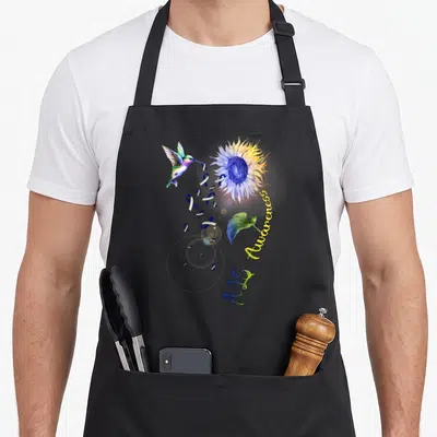 Als sunflower apron - Watercolor hummingbird, sunflower, blue ribbons, and Aids Awareness text in blue yellow and purple — shown on a black cotton canvas apron against a white background
