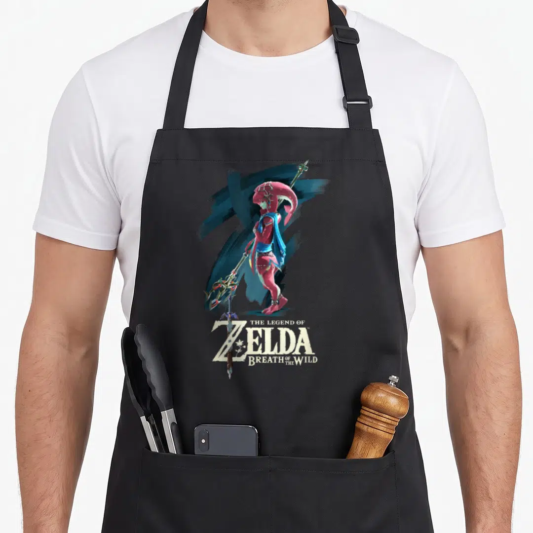 Breath paint apron - Mipha character holding spear in red blue with Legend of Zelda text below — shown on a black cotton canvas apron against a white background