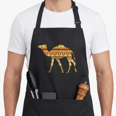 Middle camel apron - Camel silhouette filled with yellow orange blue red geometric patterns on black background — shown on a black cotton canvas apron against a white background