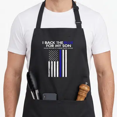 Blue mom and son aprons - I Back The Blue For My Son text above distressed white and blue flag — shown on a black cotton canvas apron against a white background